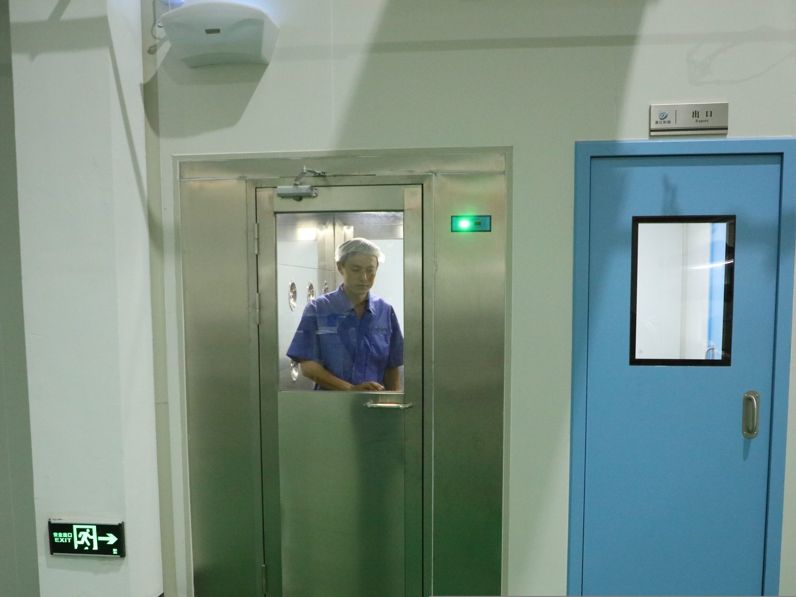 Operator passing through the cleanroom air shower before entering production