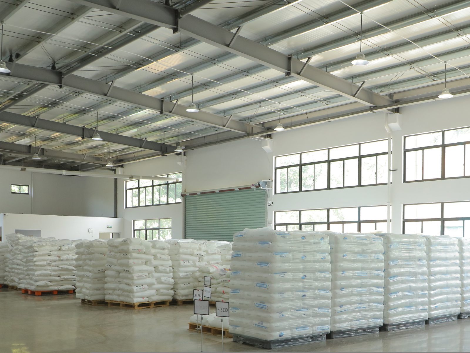Palletised raw material bags in the resin warehouse